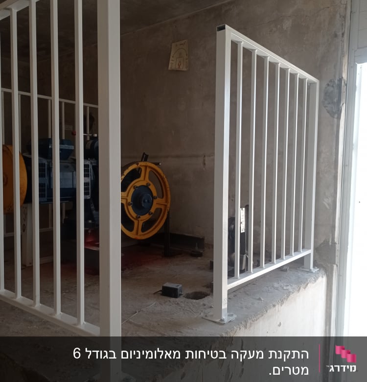 מעקה מתכת לבן מותקן על רצפת בטון